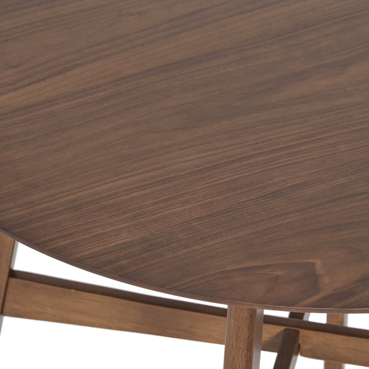 Round walnut dining table surface with visible wood grain