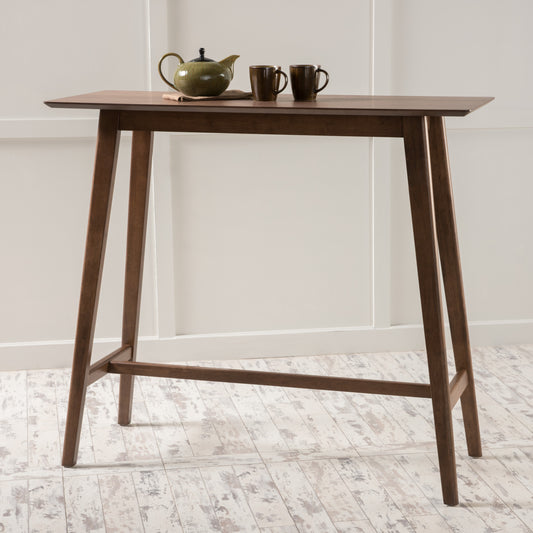 Dark walnut bar table with two brown ceramic mugs and green teapot