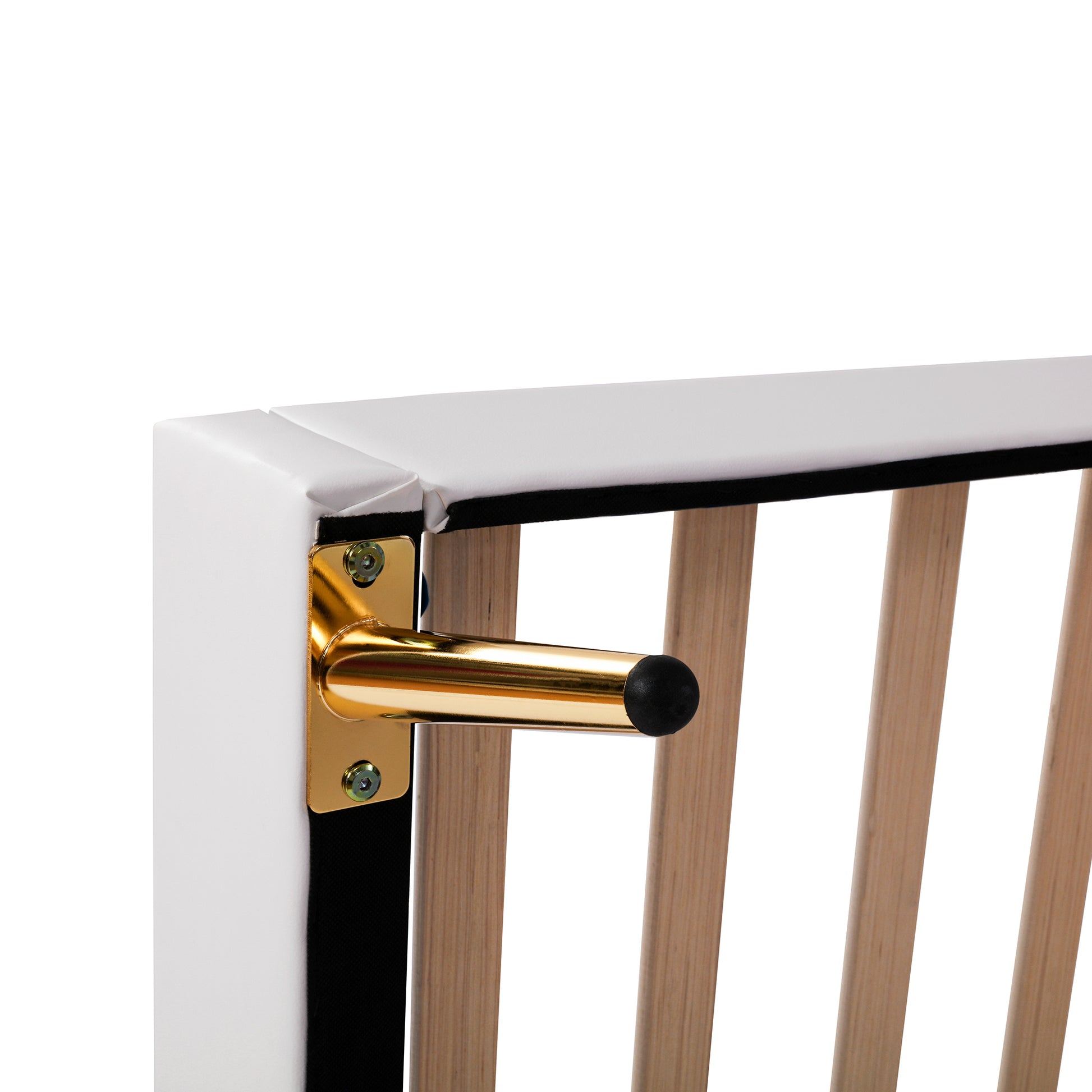 Gold tapered leg detail on a white upholstered bed frame