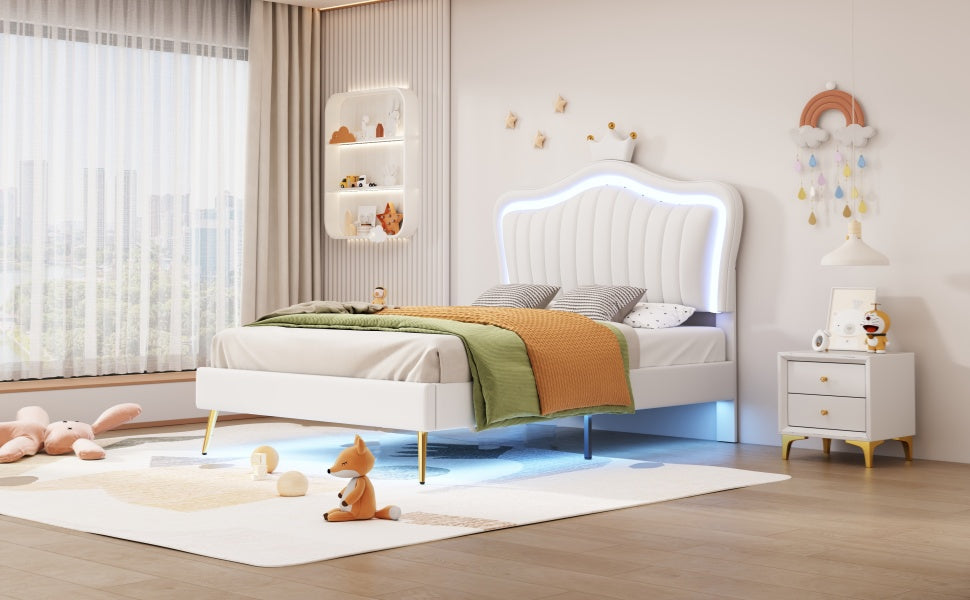 White velvet upholstered bed with scalloped headboard and LED lighting