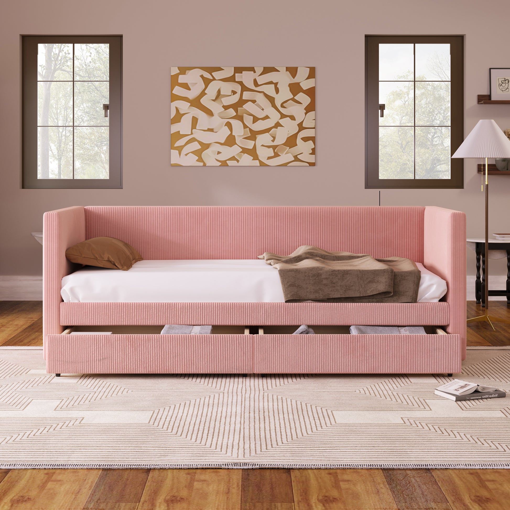 Pink corduroy daybed with storage drawers and a brown pillow