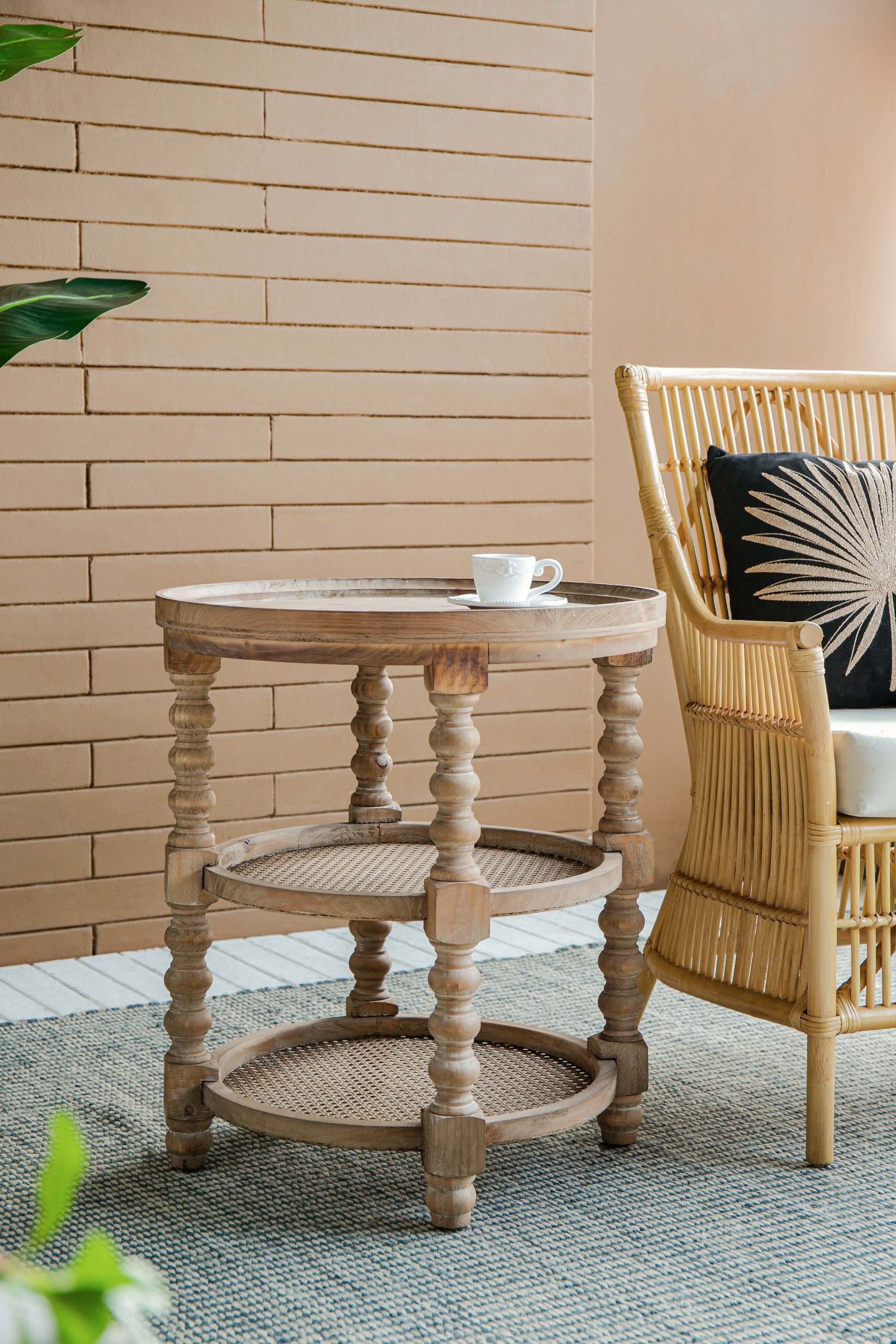 Vintage wooden side table with turned legs and cane shelving