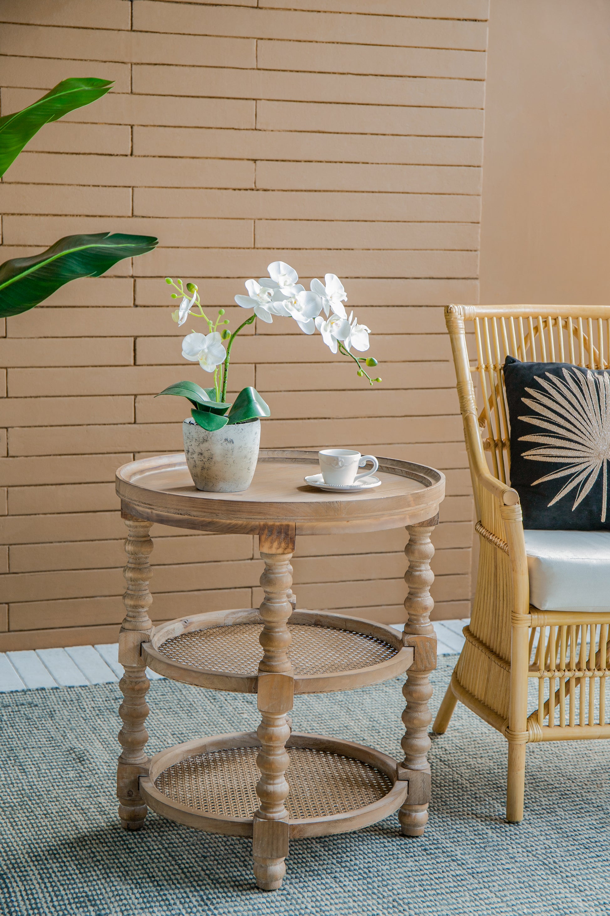 Rustic wooden side table with white orchid and coffee cup