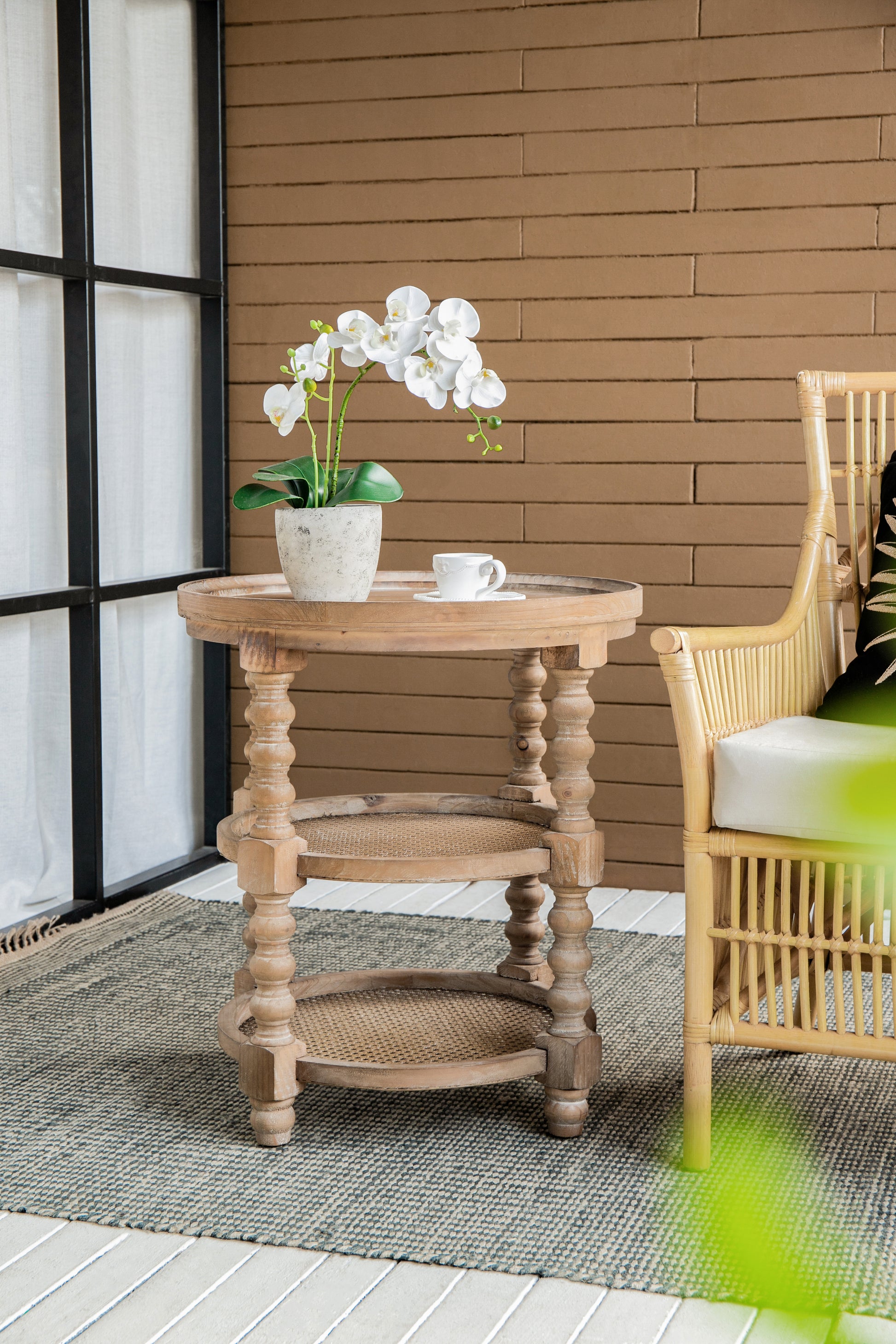 Rustic wood accent table with white orchid and teacup