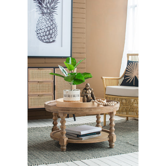Round distressed wood coffee table with cane shelf