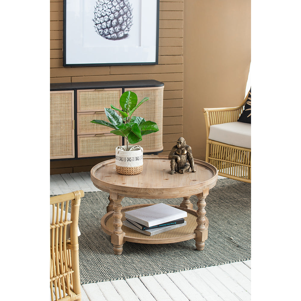Round natural wood coffee table with tiered storage and ornate legs