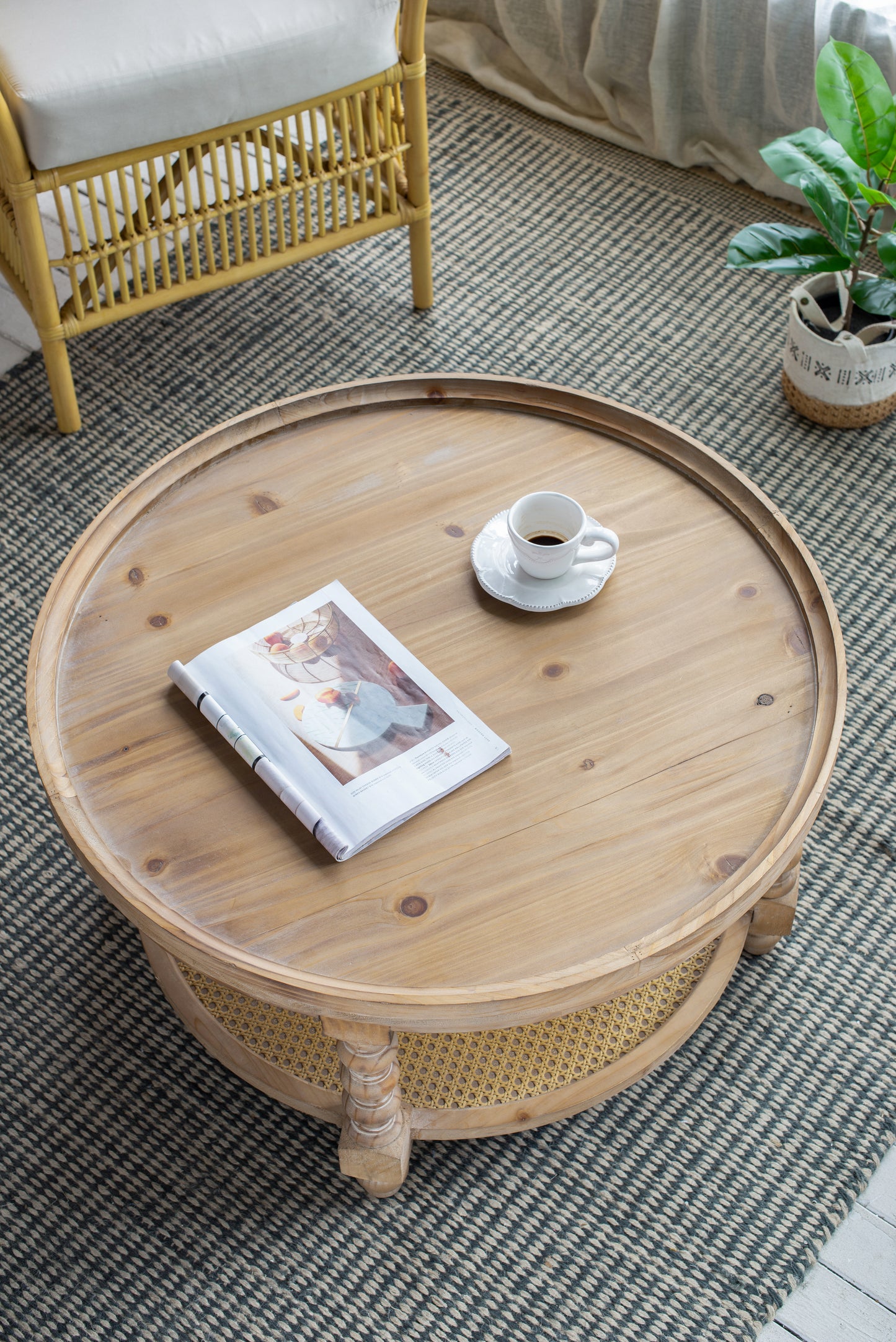 Round pine wood coffee table with magazine and coffee cup