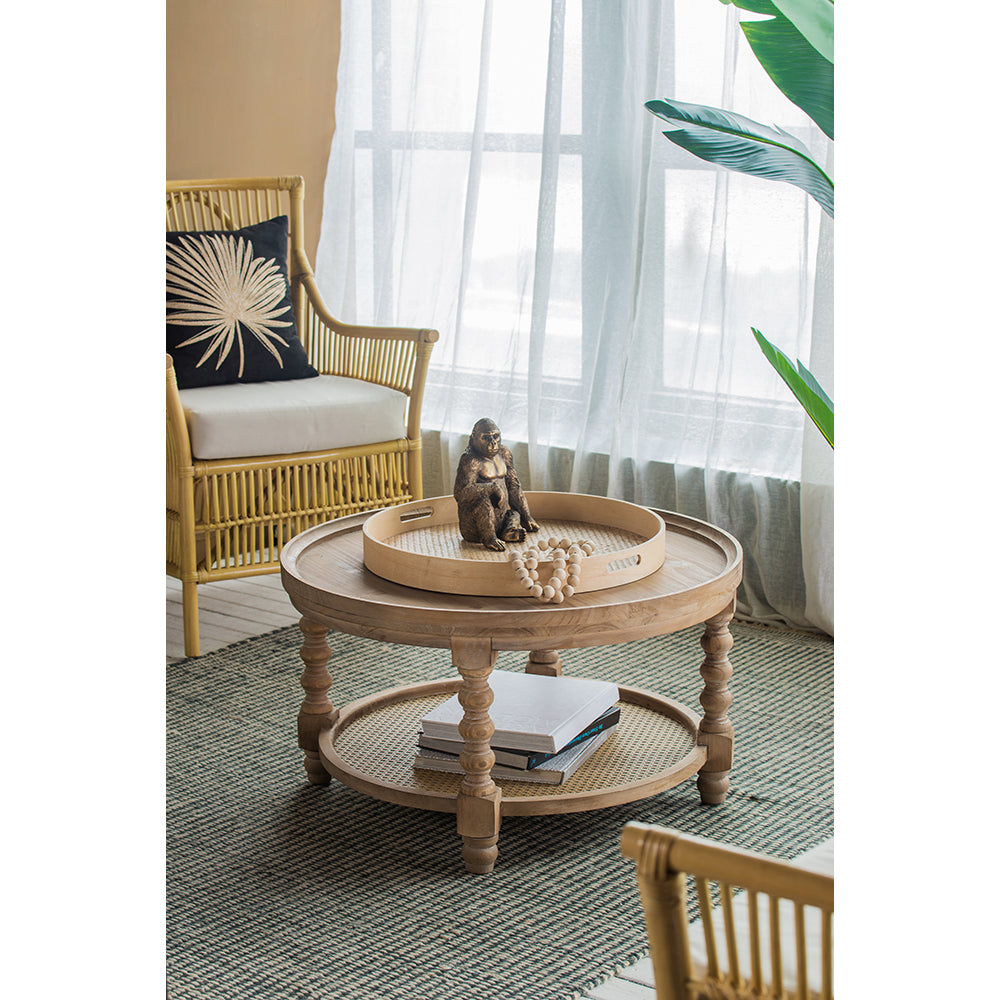 Rattan accent chair with black leafpatterned pillow