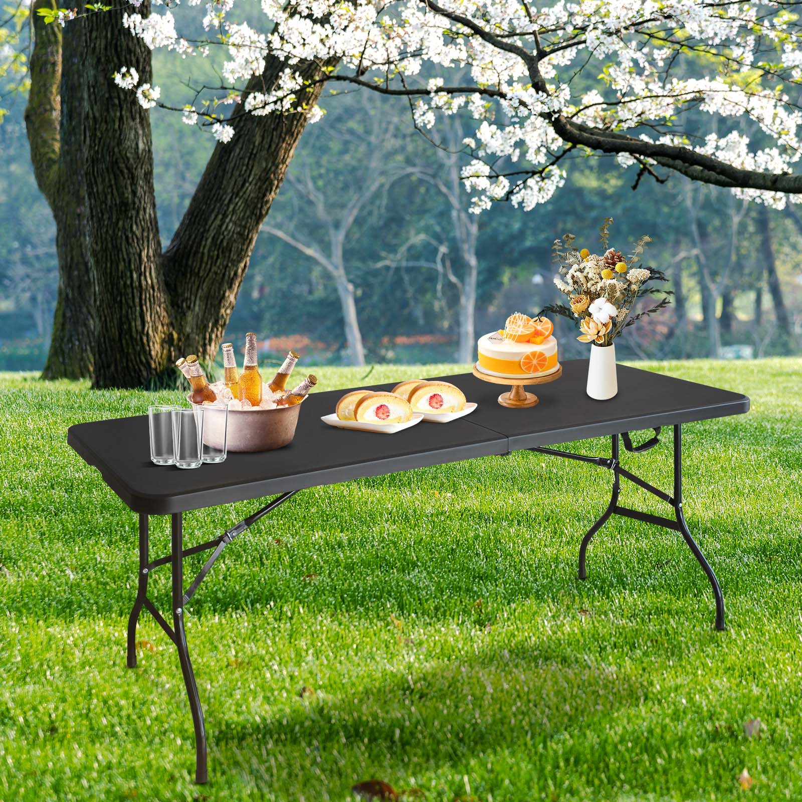 Black folding table set up outdoors with drinks and cake