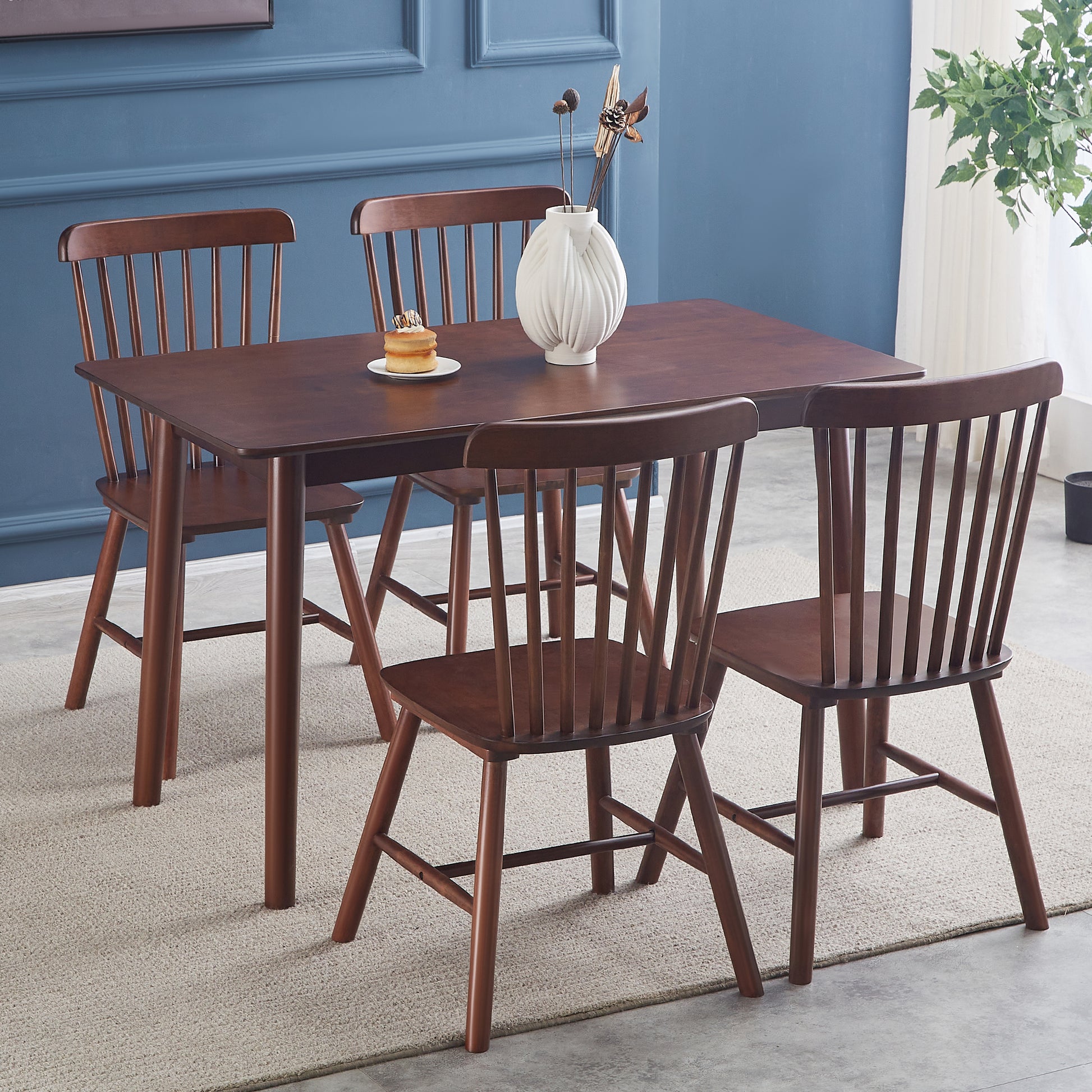 Dark wood dining table with four matching chairs