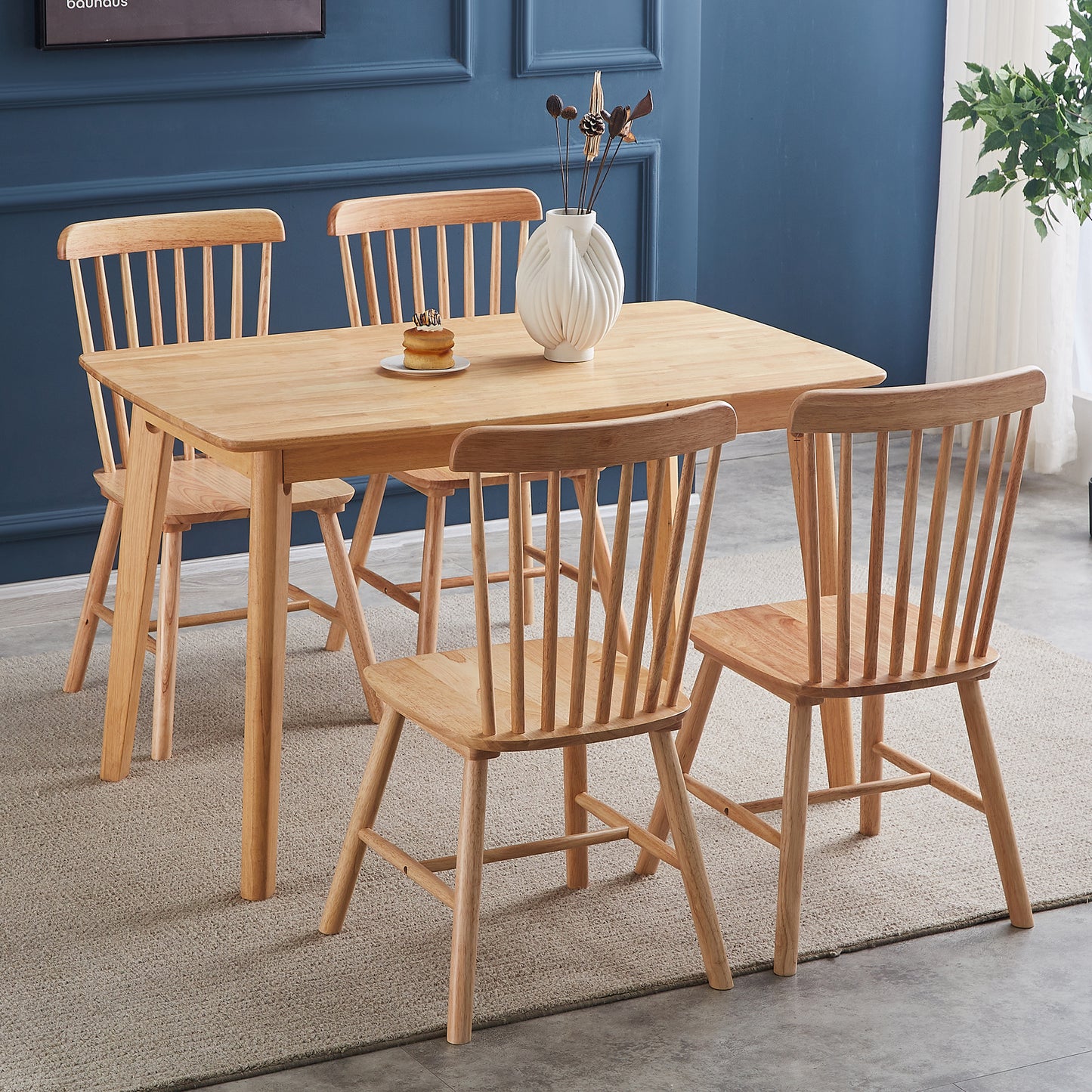 Natural wood dining table and four chairs with spindle backs