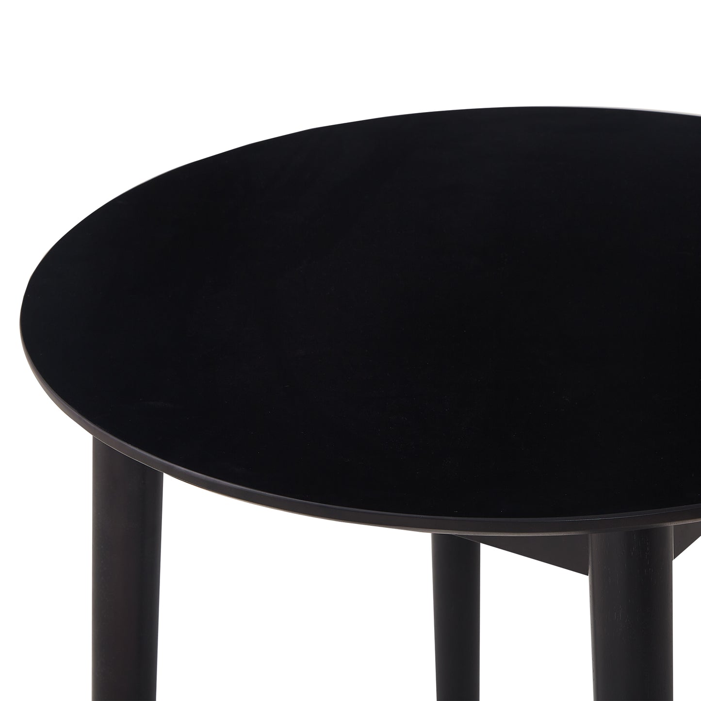 Closeup of a modern black round coffee table with minimalist wooden legs