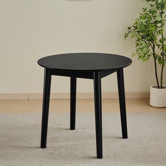 Black round dining table with tapered legs