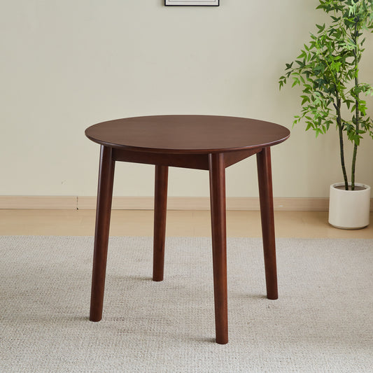 Round walnut dining table with tapered legs