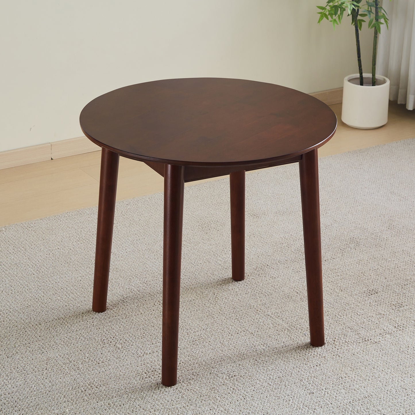 Dark brown round coffee table with tapered wooden legs