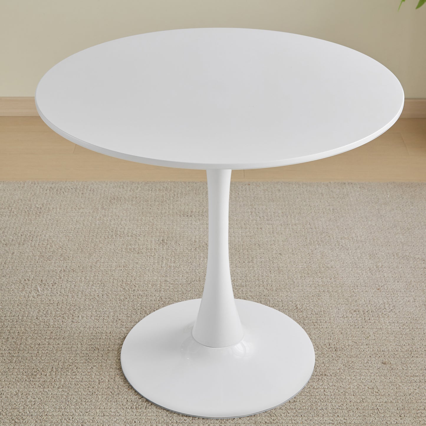 Round white tulip dining table with a pedestal base