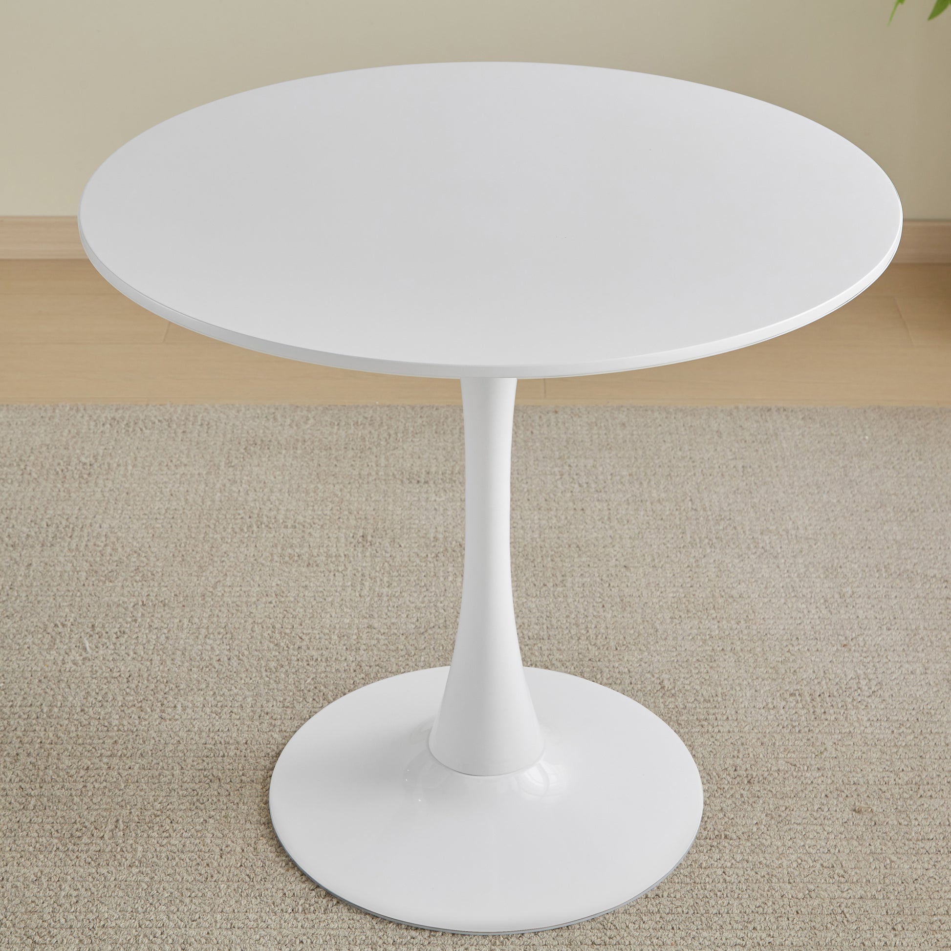 Round white tulip dining table with a pedestal base
