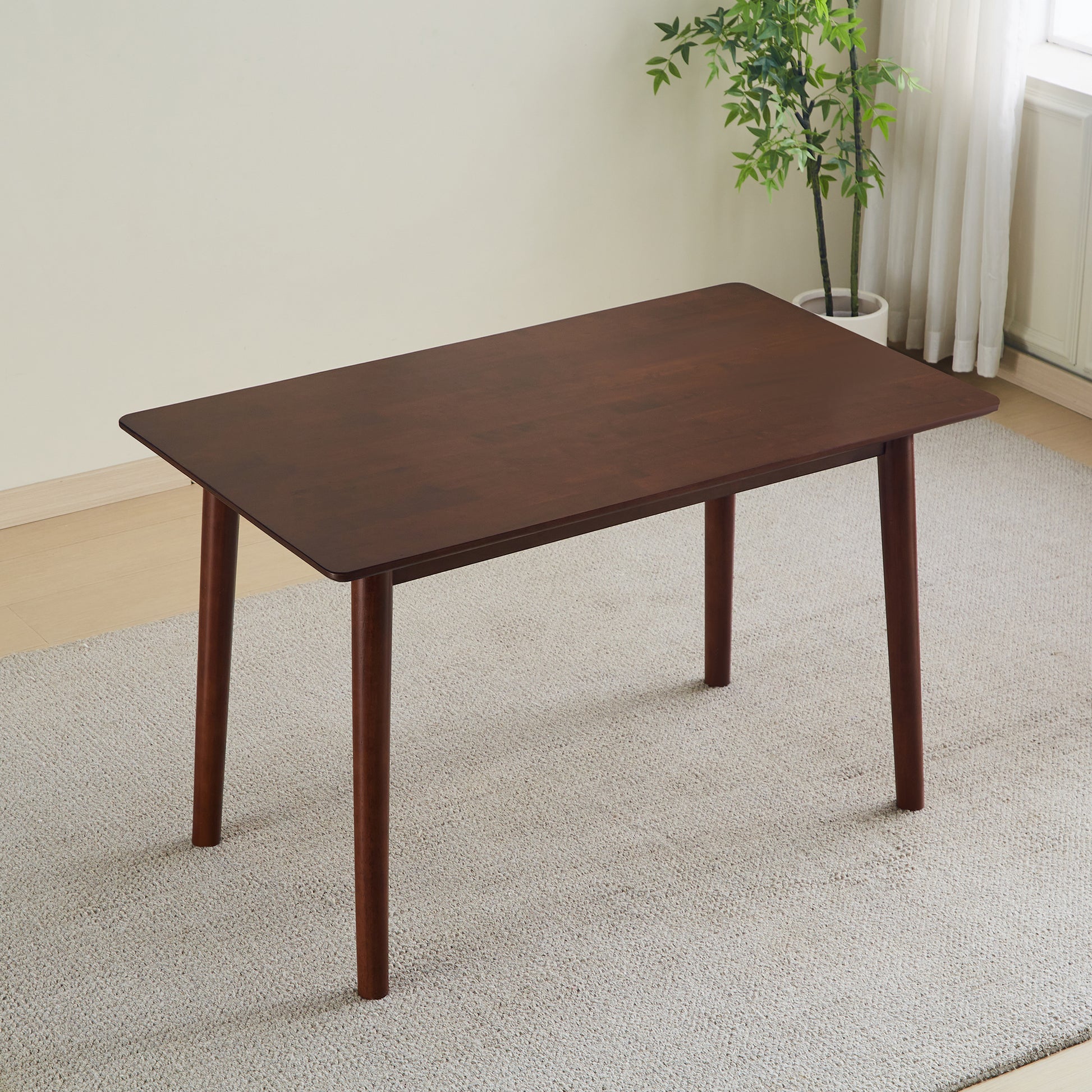 Dark wood rectangular dining table with rounded corners
