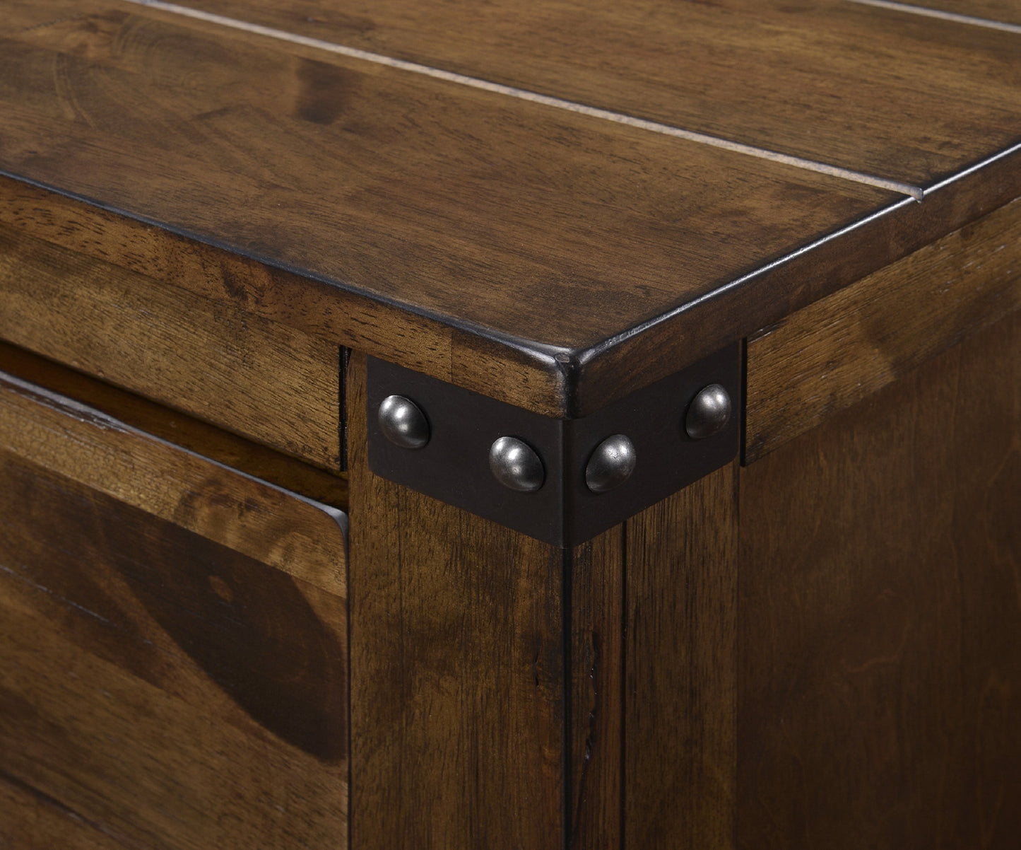 Dark wood dresser corner with metal rivets