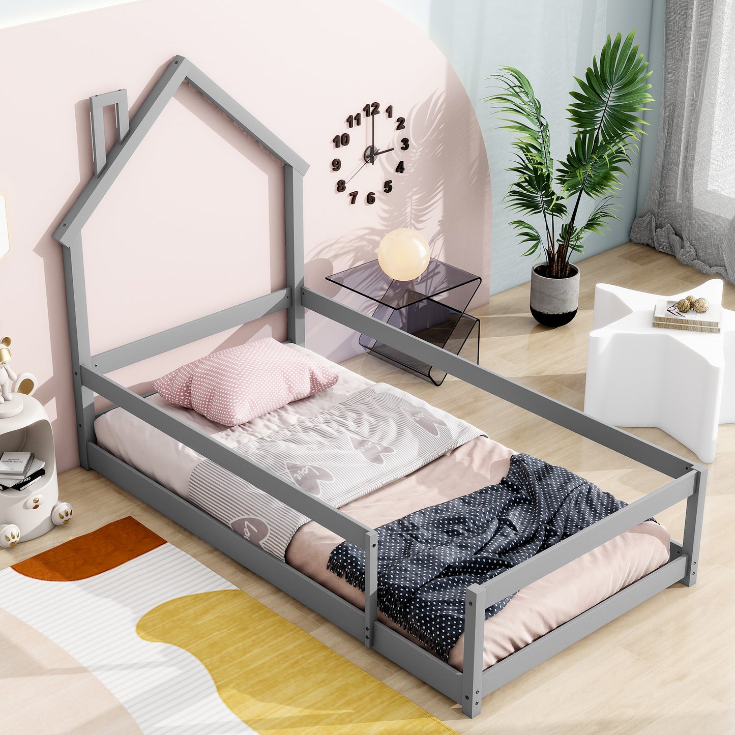 Gray wooden house bed frame with pink bedding and a patterned blanket