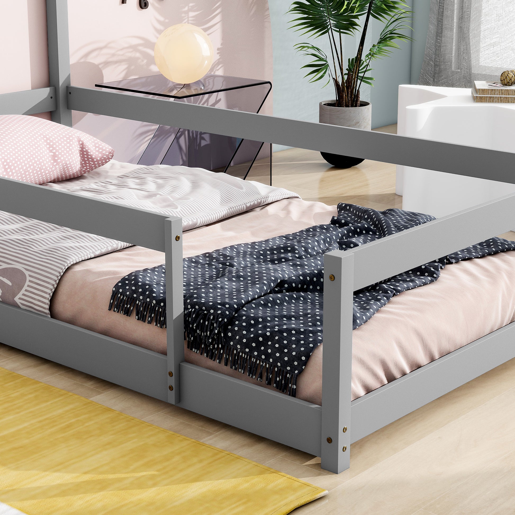 Gray wooden twin bed frame with pink and gray bedding
