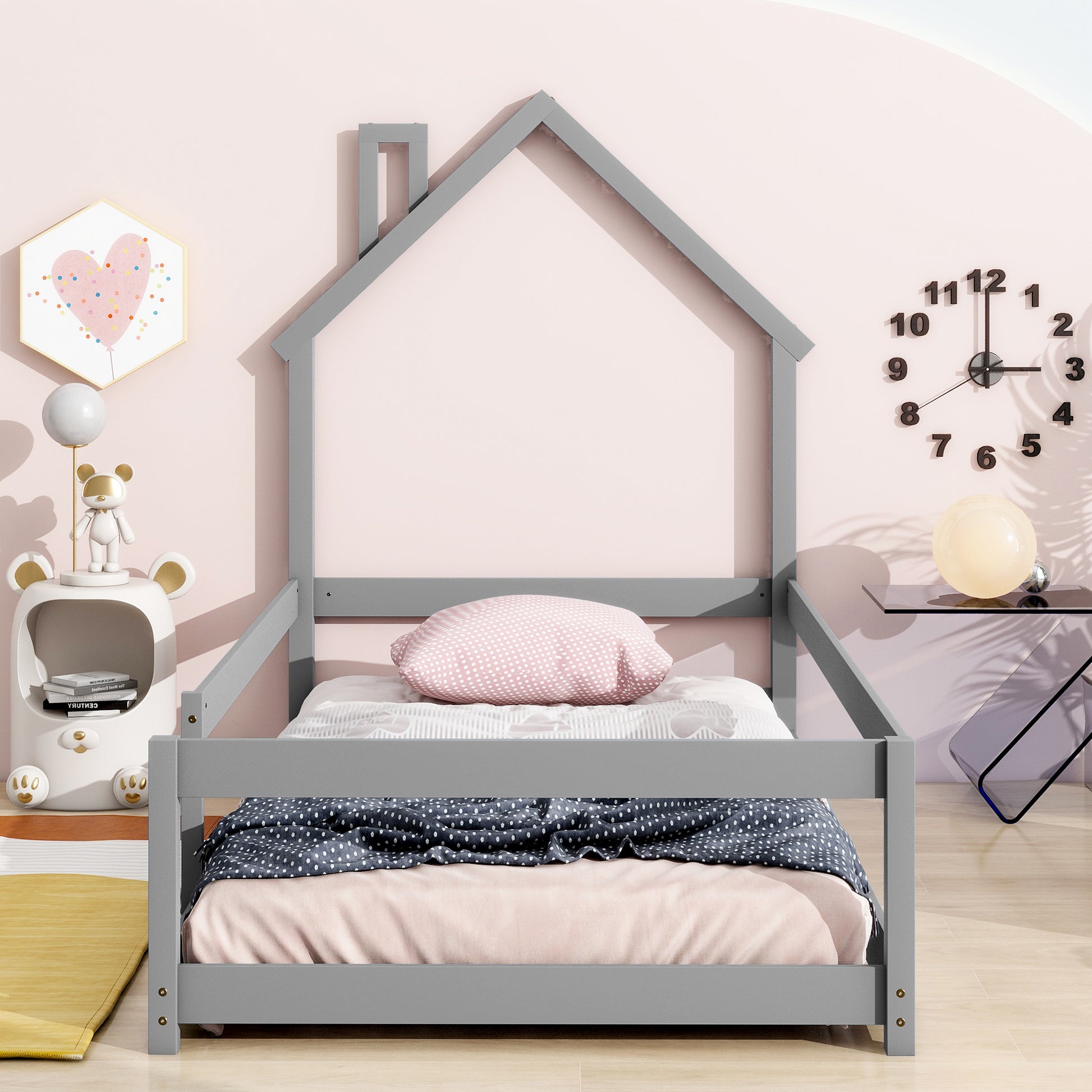 Gray wooden house bed frame with playful pink and white bedding