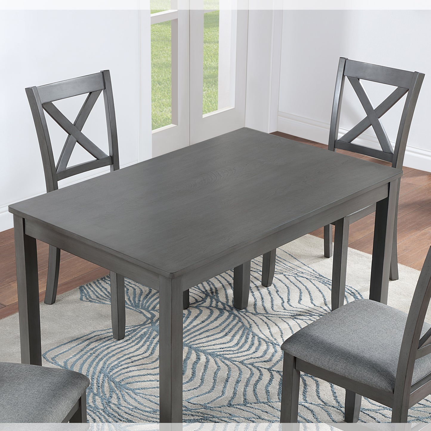 Gray rectangular dining table with four matching chairs