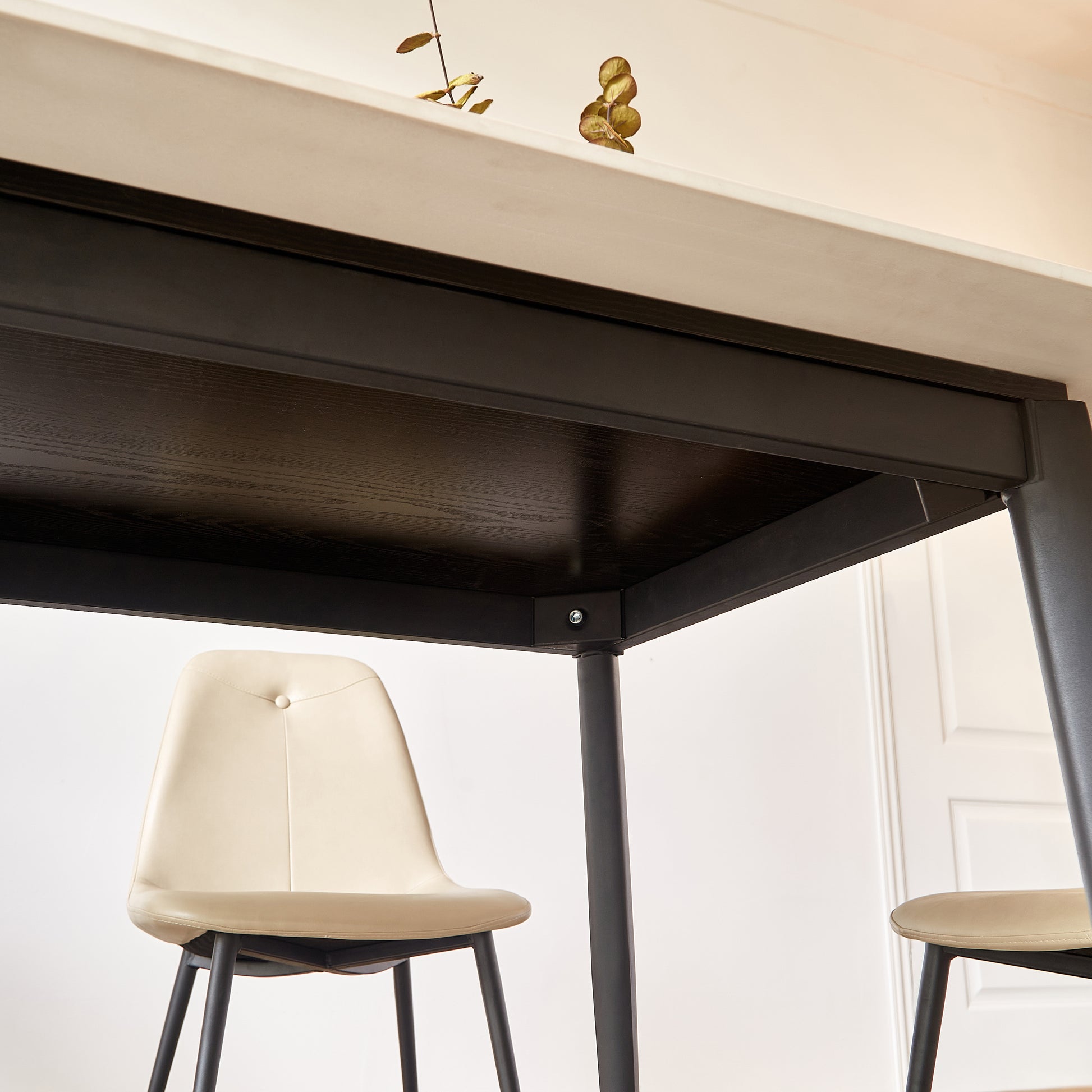 Cream tufted upholstered dining chair with black metal legs