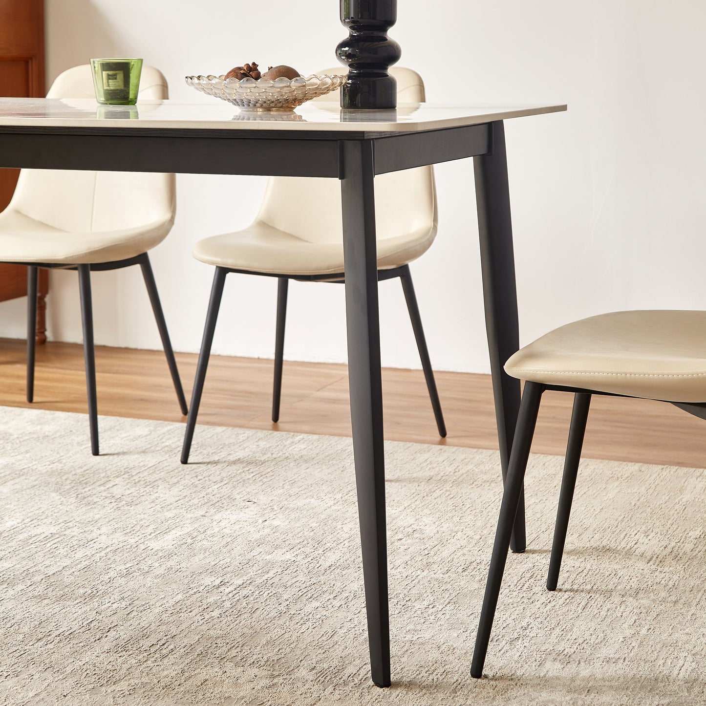 Modern dining table with black legs and a light wood finish top