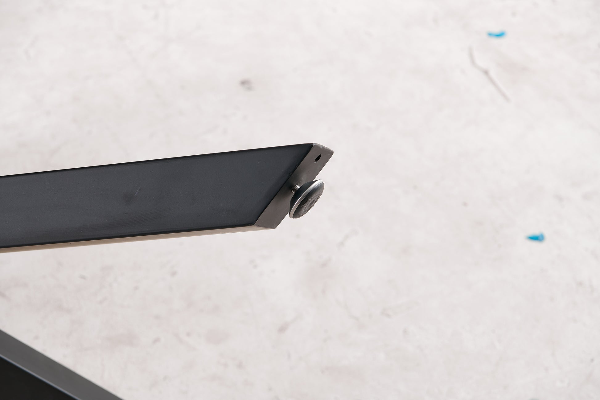 Black metal table leg with adjustable foot