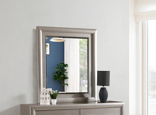 Silver framed wall mirror with ornate detailing