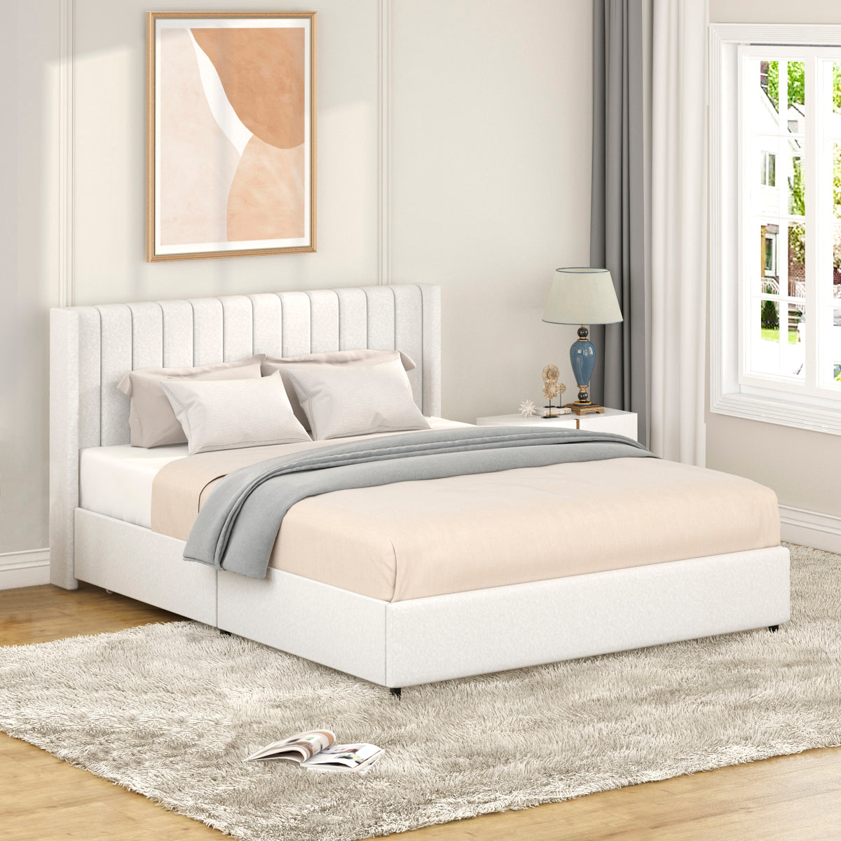 Elegant upholstered queen bed frame in white fabric with a padded vertical channel headboard