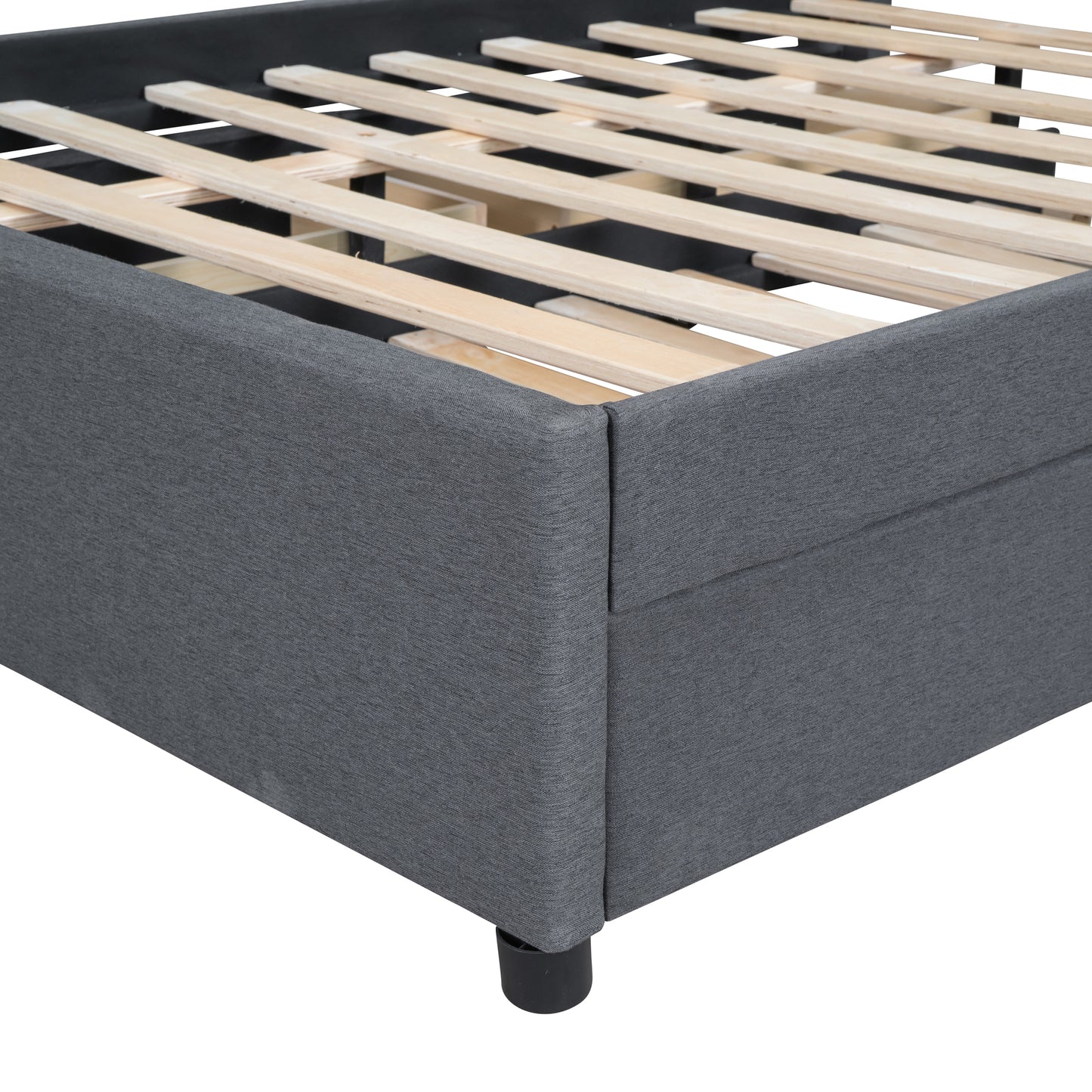 Closeup of a charcoal grey fabric upholstered bed frame with a wooden slat support system