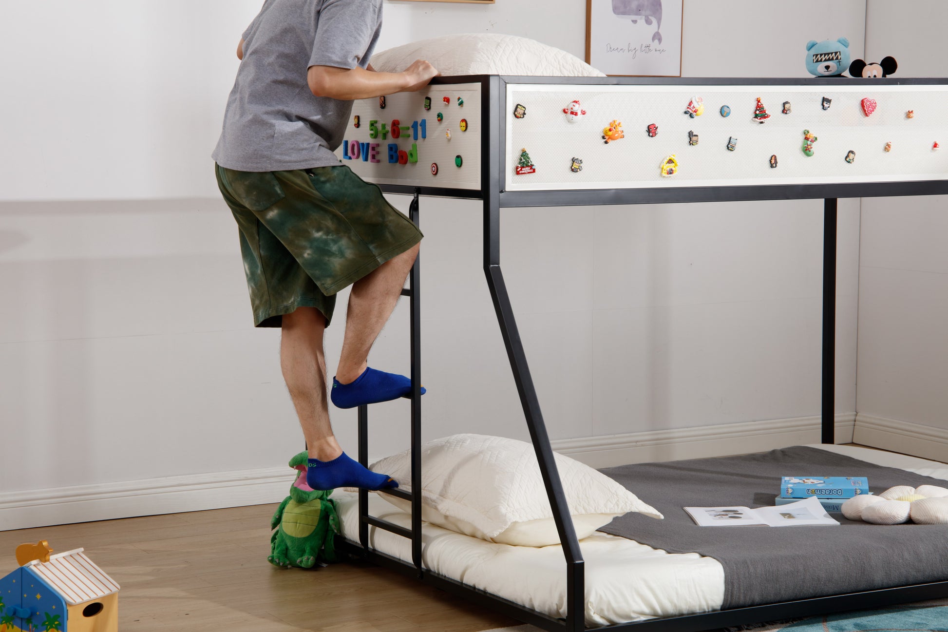 Black metal twin over twin bunk bed with decorative magnets on the side