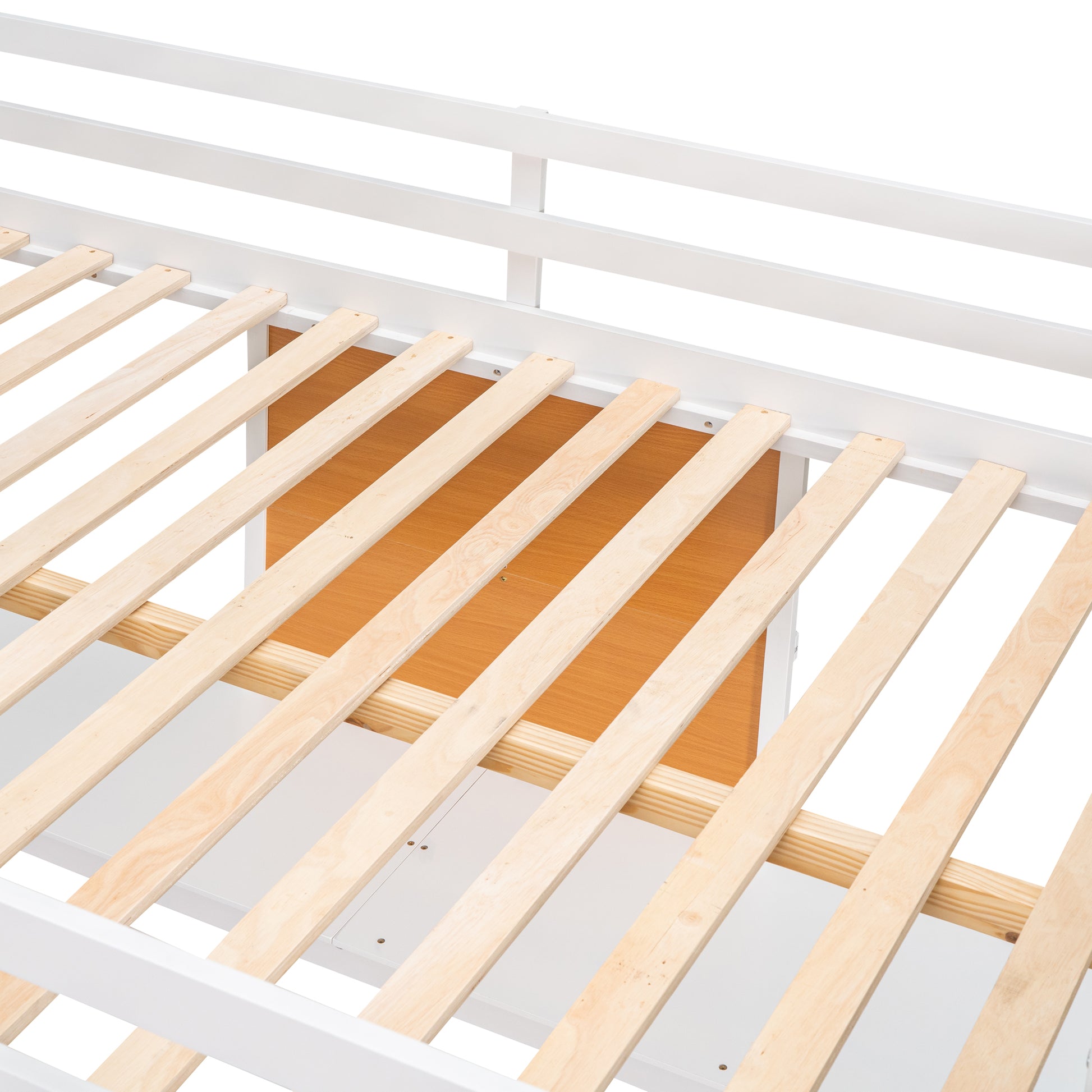 Closeup of white metal bed frame with wooden slats and builtin drawer