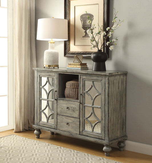 Distressed grey accent cabinet with mirrored doors and antique brass hardware