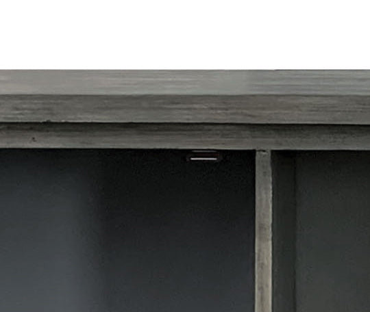 Close up of a gray distressed wood shelf with two dark compartments
