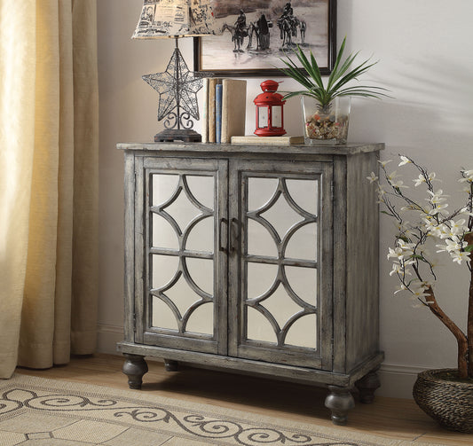 Gray distressed accent cabinet with mirrored geometric doors