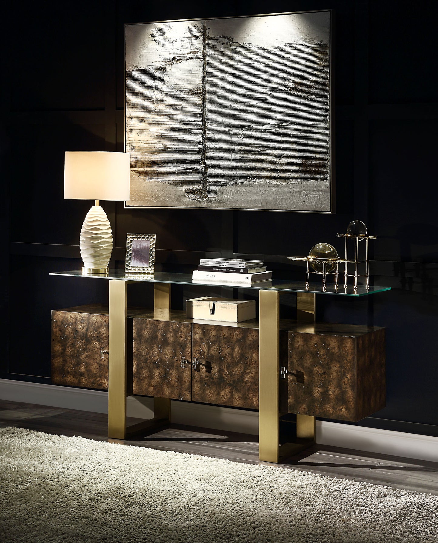 Glass top console table with bronze cabinets and gold legs