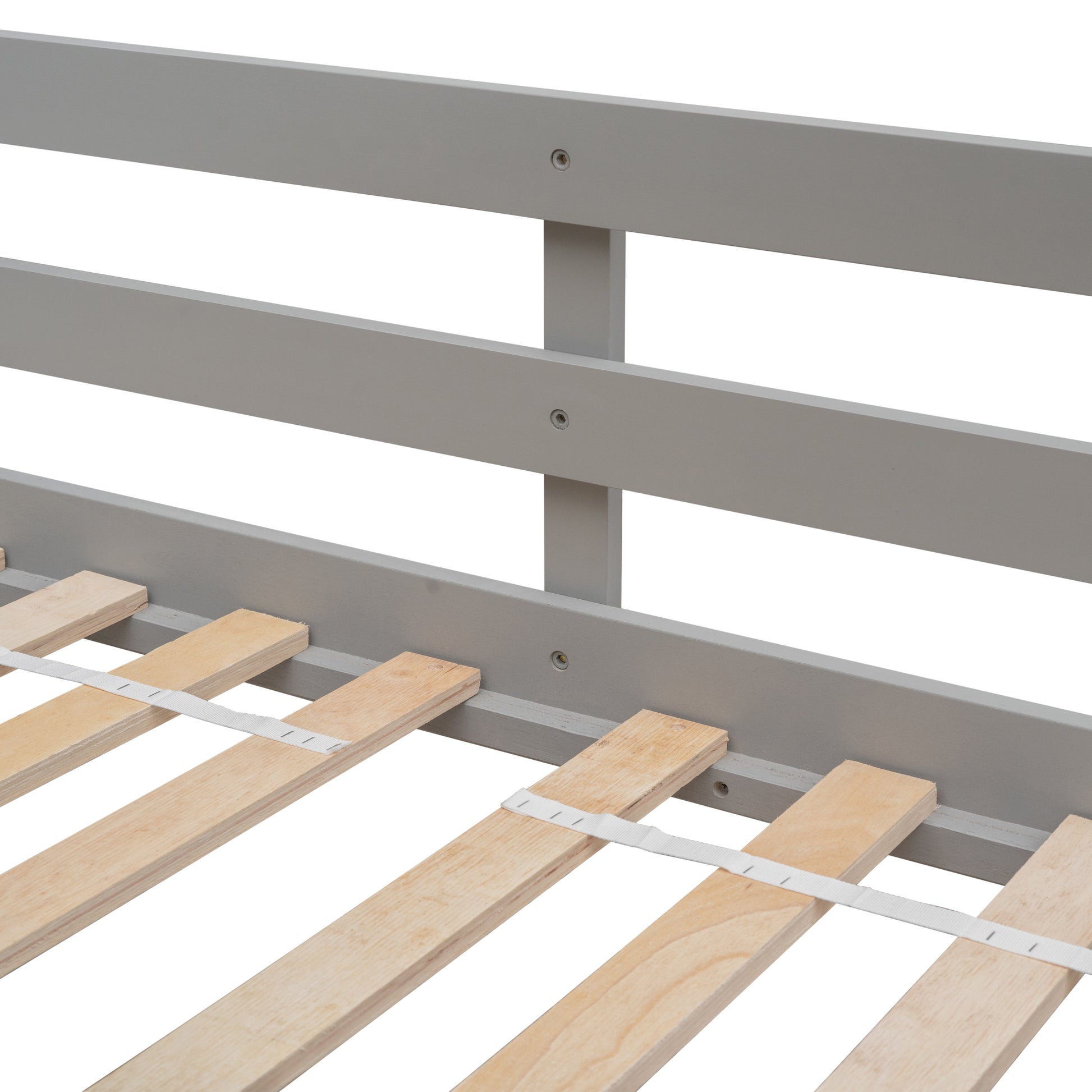 Gray wooden bed frame detail with natural wood slats and support strap