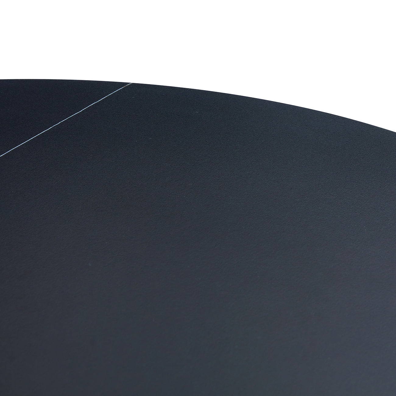 Closeup of textured dark grey laminate countertop edge with subtle scratch detail