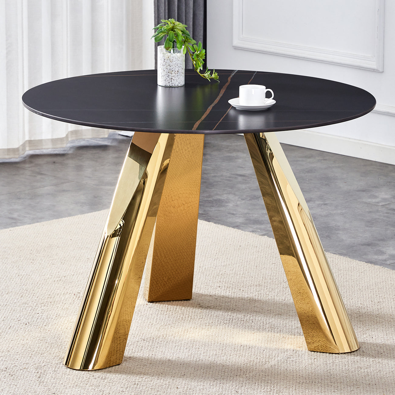 Round black marble dining table with striking gold legs