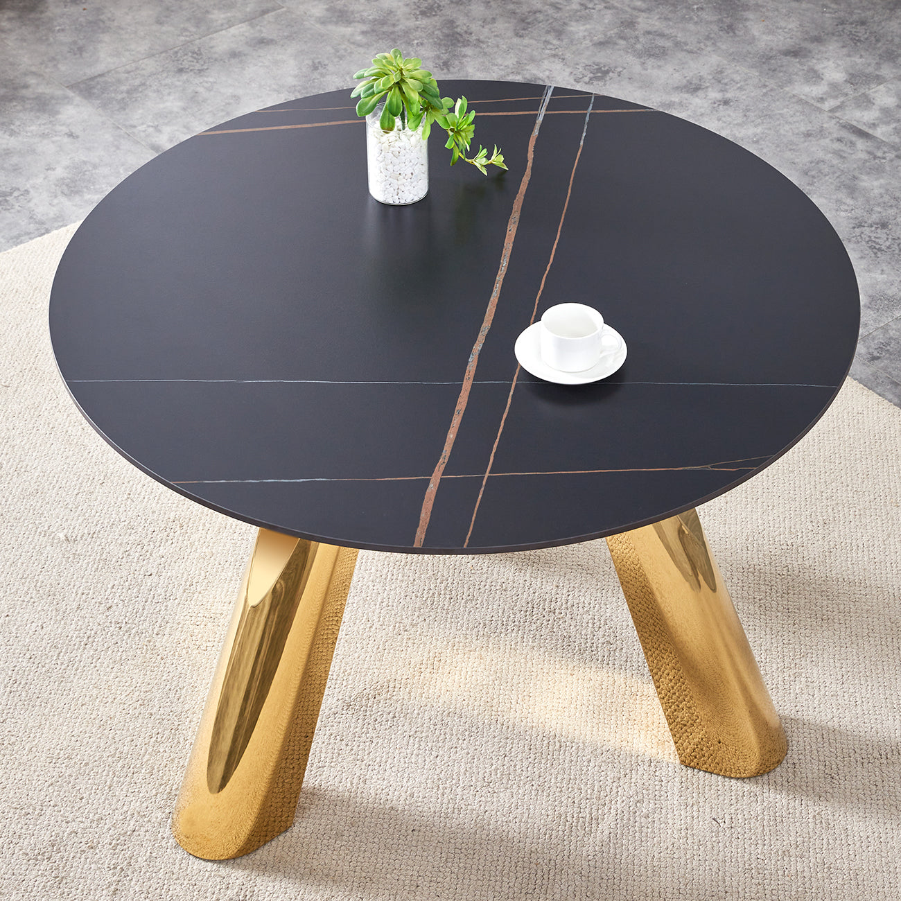 Black marble coffee table with gold legs and marble inlay