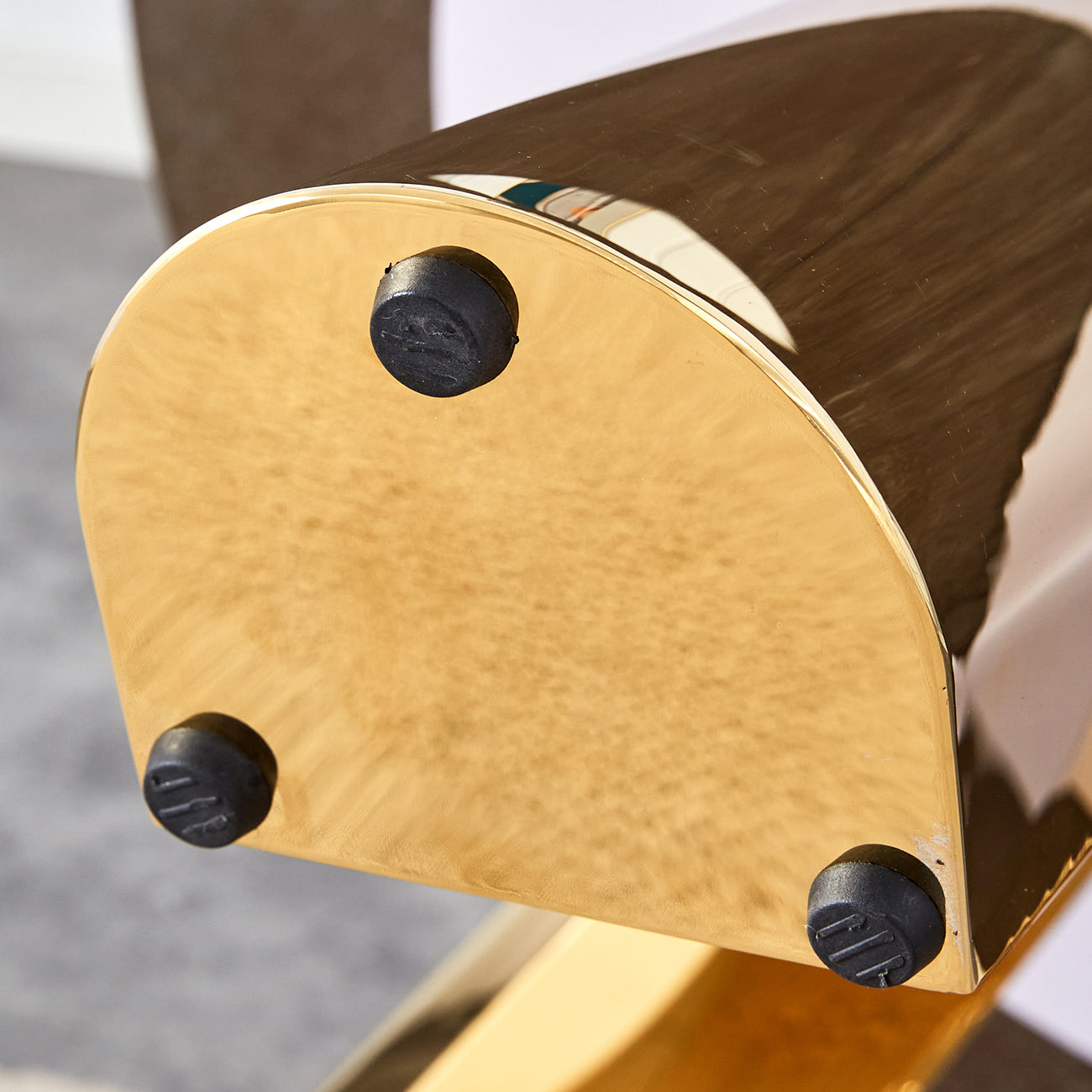 Round gold coffee table base with three black protective feet