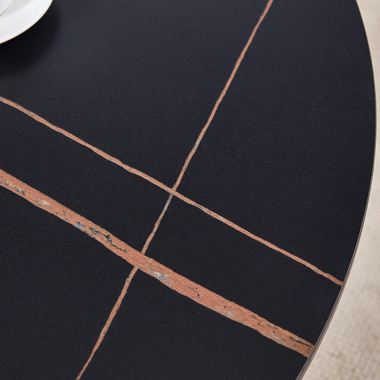 Black round marble coffee table with copper veining