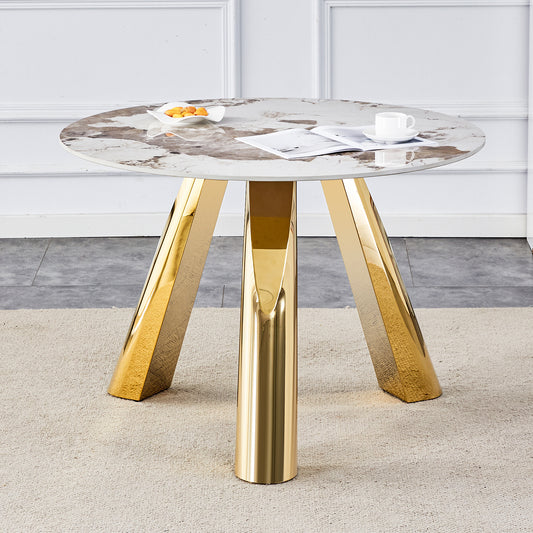 Round marble top dining table with polished gold pedestal legs