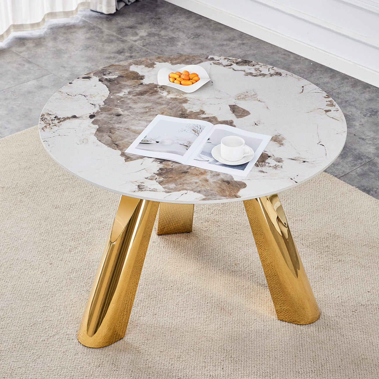 Round marble coffee table with unique gold metal legs
