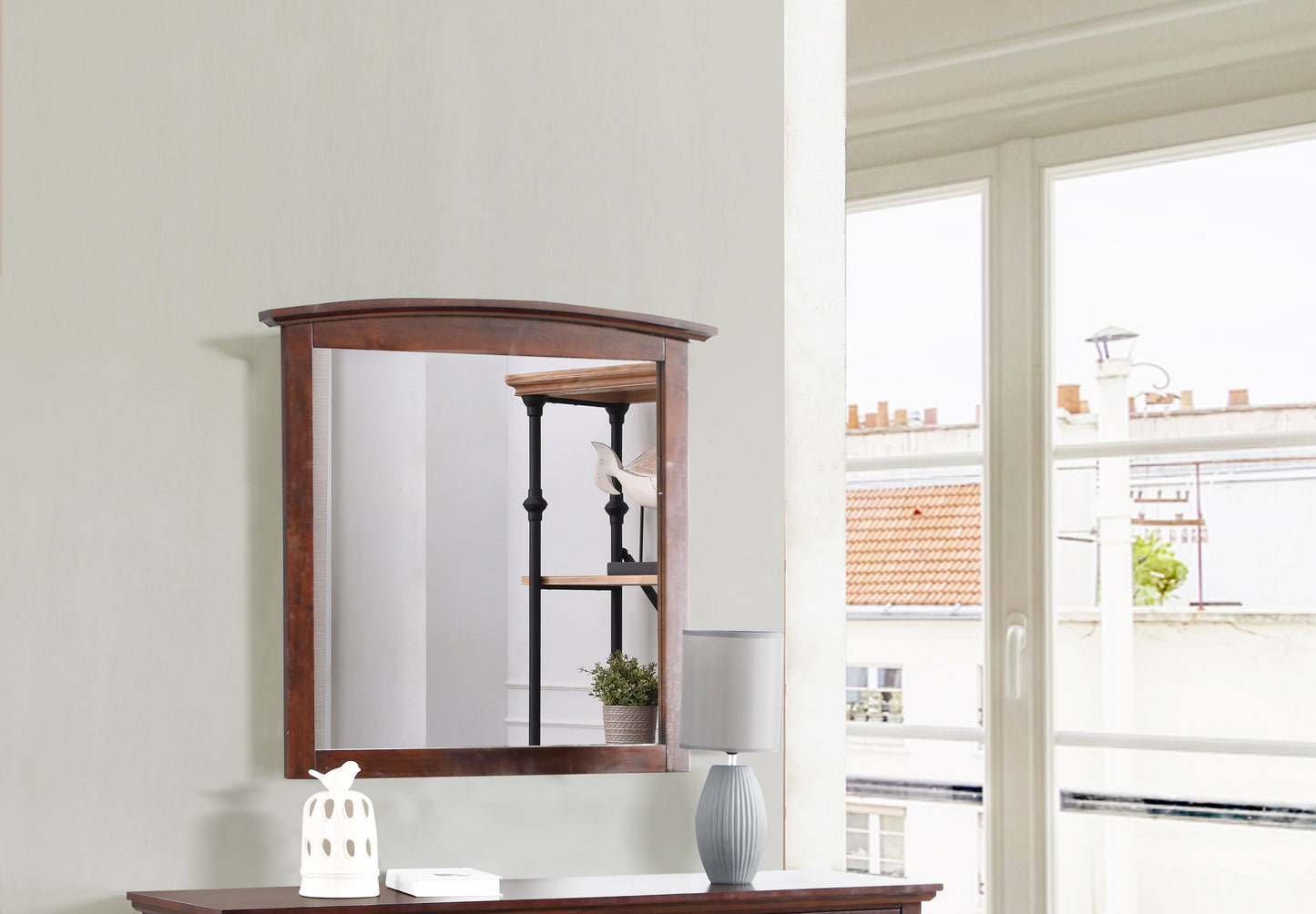 Dark wood framed accent mirror with a subtle curved top