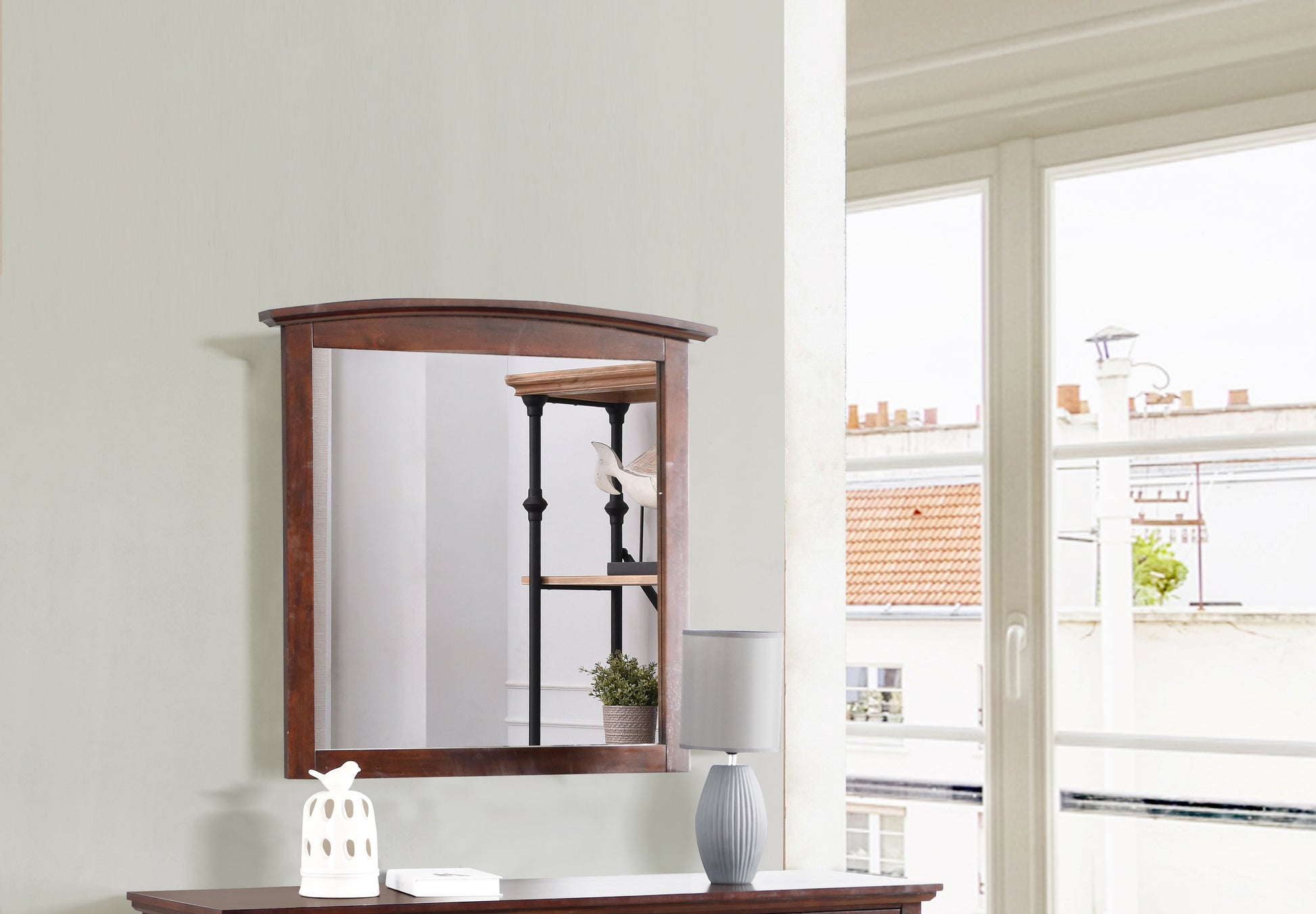 Dark wood framed accent mirror with a subtle curved top