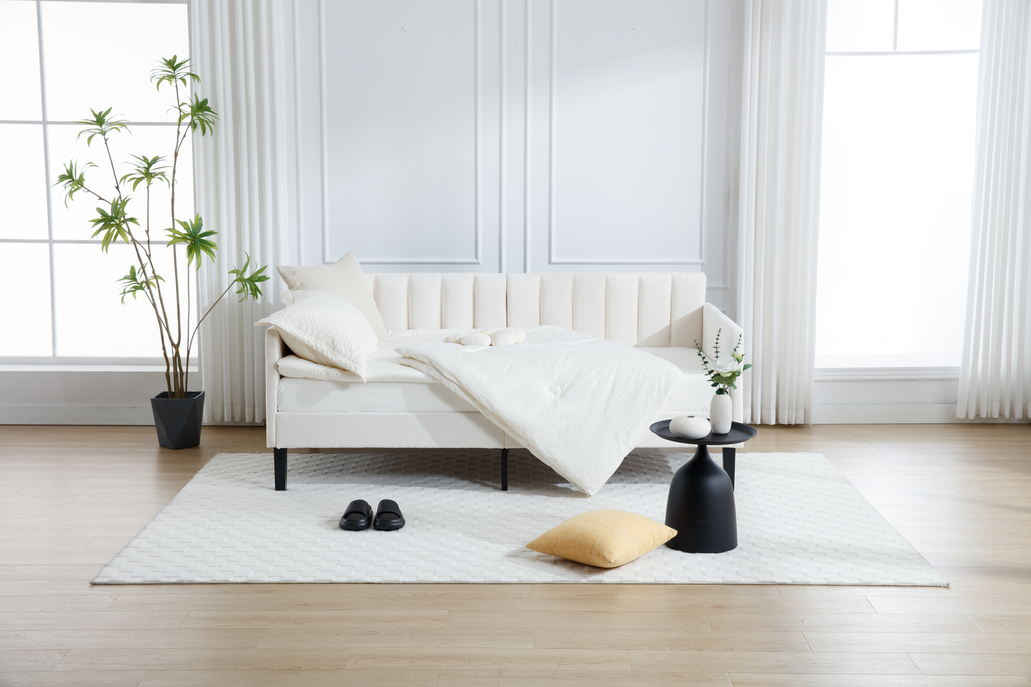Elegant white tufted sofa with plush bedding and accent pillows